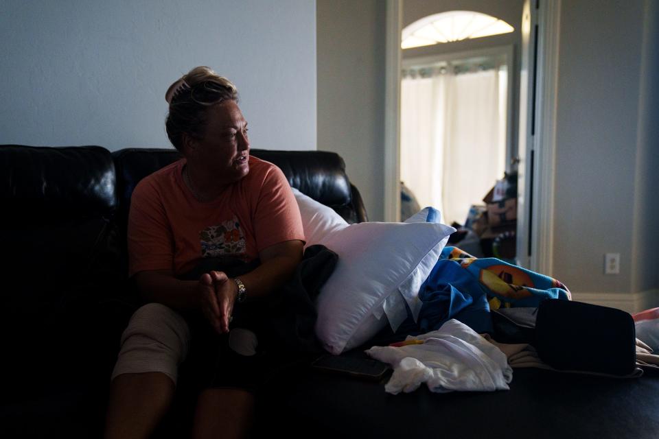 Oct 5, 2022; Fort Myers, FL, USA; Olivia Johnson talks about sheltering several of her neighbors in the second floor of her home as they were trying to escape major flooding caused Hurricane Ian. Ian caused catastrophic damage across southwest Florida when it came ashore as a Category 4 storm.. Mandatory Credit: Josh Morgan-USA TODAY
