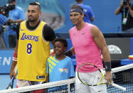 Australia's Nick Kyrgios, left, poses for a photo with Rafael Nadal, wearing a shirt as a tribute to Kobe Bryant ahead of his fourth round singles match at the Australian Open tennis championship in Melbourne, Australia, Monday, Jan. 27, 2020. (AP Photo/Lee Jin-man)