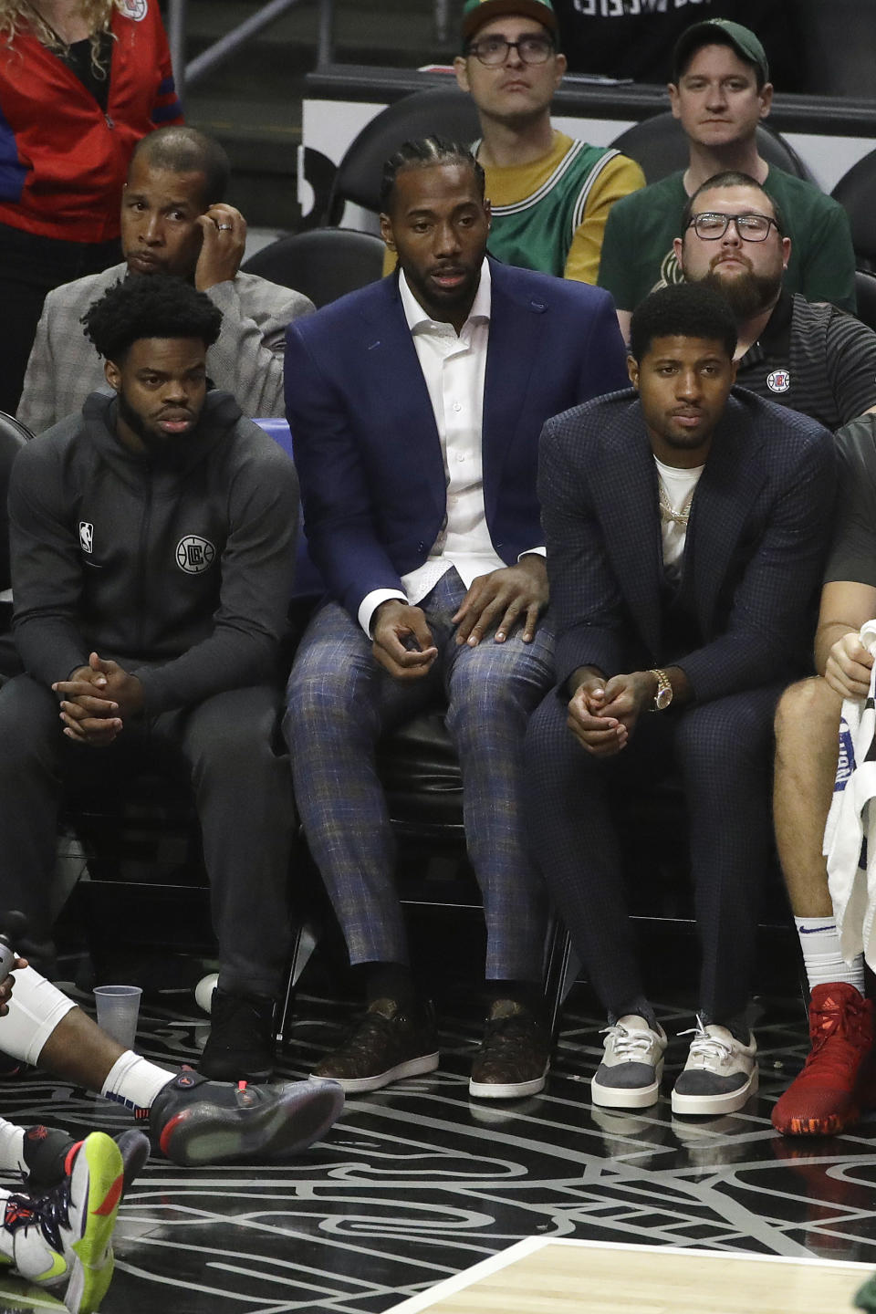 Los Angeles Clippers' Kawhi Leonard, center, and Paul George, right, watch from the bench during the second half of the team's NBA basketball game against the Milwaukee Bucks on Wednesday, Nov. 6, 2019, in Los Angeles. (AP Photo/Marcio Jose Sanchez)