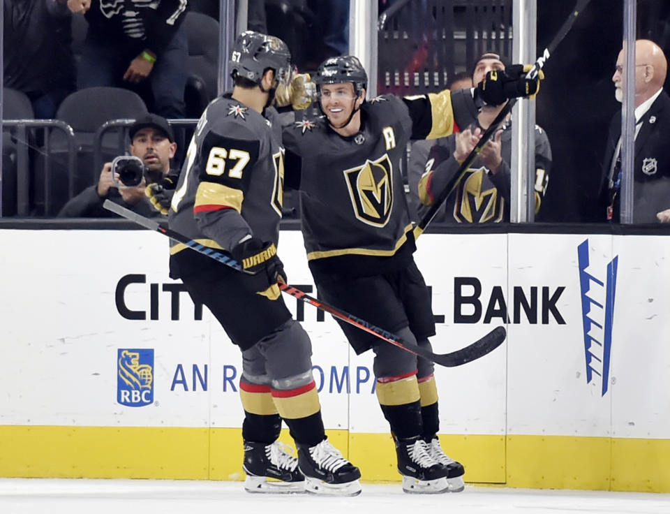 Vegas Golden Knights left wing Max Pacioretty (67) and center Jonathan Marchessault (81) react after Marchessault's goal during the first period of an NHL hockey game against the Buffalo Sabres, Tuesday, Oct. 16, 2018, in Las Vegas. (AP Photo/David Becker)