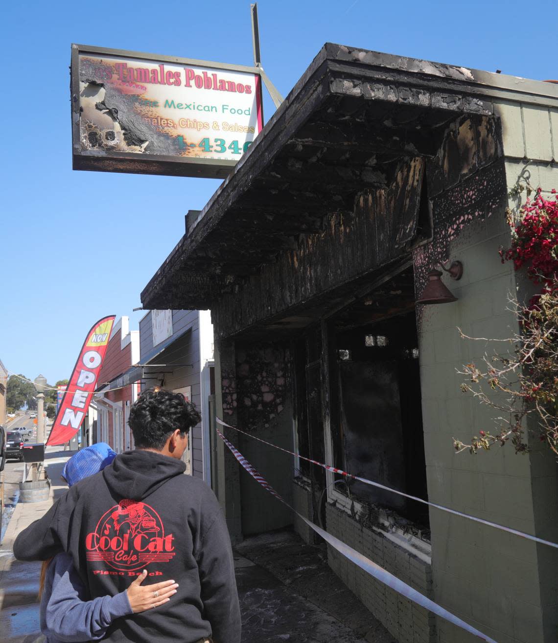 Jami Wozniak, left, school counselor at Judkins Middle School, gives a hug to Antonio Hernandez, whose family lost their Oceano restaurant to an early-morning fire on Friday, May 12, 2023. She was coordinating relief efforts, and those who want to contribute can call 805-474-3600.