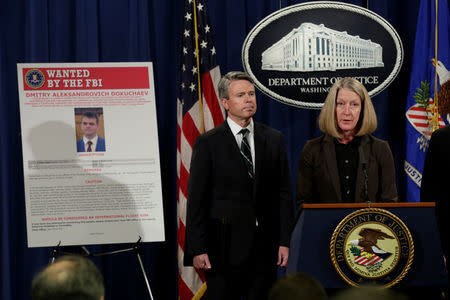 Acting AAG for National Security Mary McCord speaks in front of a poster of a suspected Russian hacker during FBI National Security Division and the U.S. Attorney's Office for the Northern District of California joint news conference at the Justice Department in Washington, U.S., March 15, 2017. REUTERS/Yuri Gripas