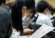 School students participate in a special lecture about national flags by Tokyo 2020 Olympic and Paralympic Games flag organiser Tadamasa Fukiura in Tokyo