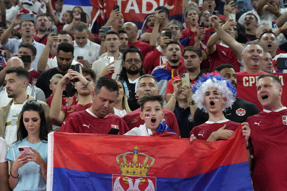 Serbia supporters cheer on the stands while waiting for the start of the World Cup group G soccer match between Brazil and Serbia, at the Lusail Stadium in Lusail, Qatar, Thursday, Nov. 24, 2022. (AP Photo/Natacha Pisarenko)