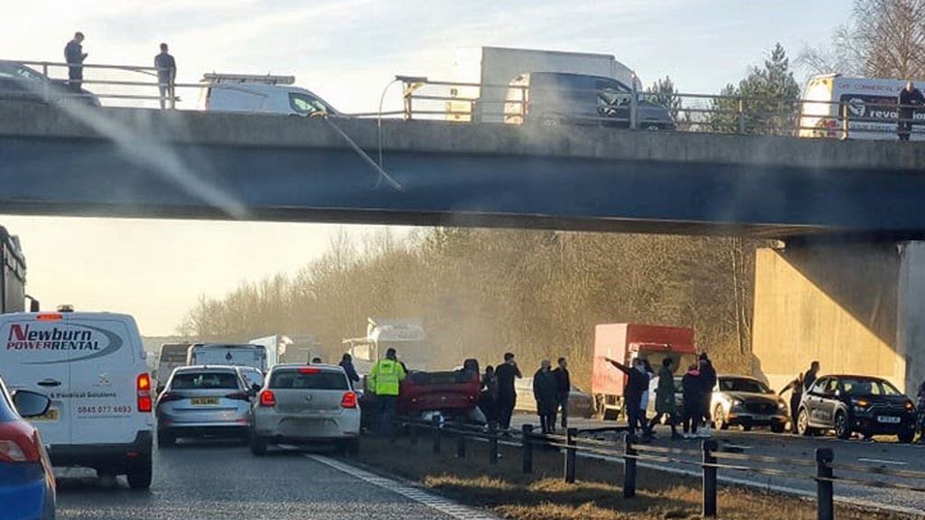 Woman in critical condition after car falls from bridge on to motorway
