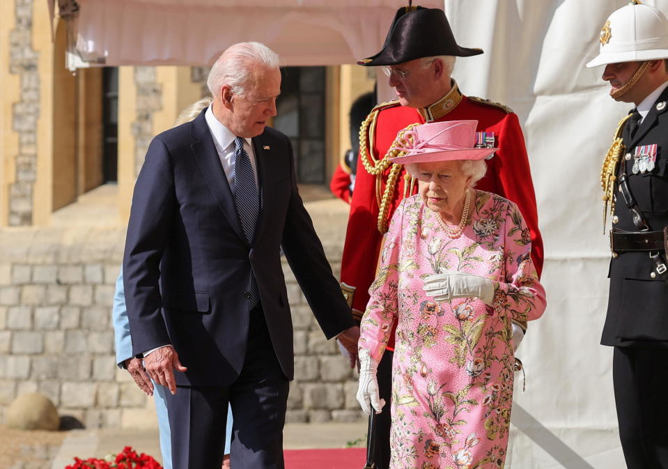 Britain's Queen Elizabeth walks with President Biden and first lady Jill Biden as they meet at Windsor Castle, on June 13, 2021. / Credit: POOL / REUTERS