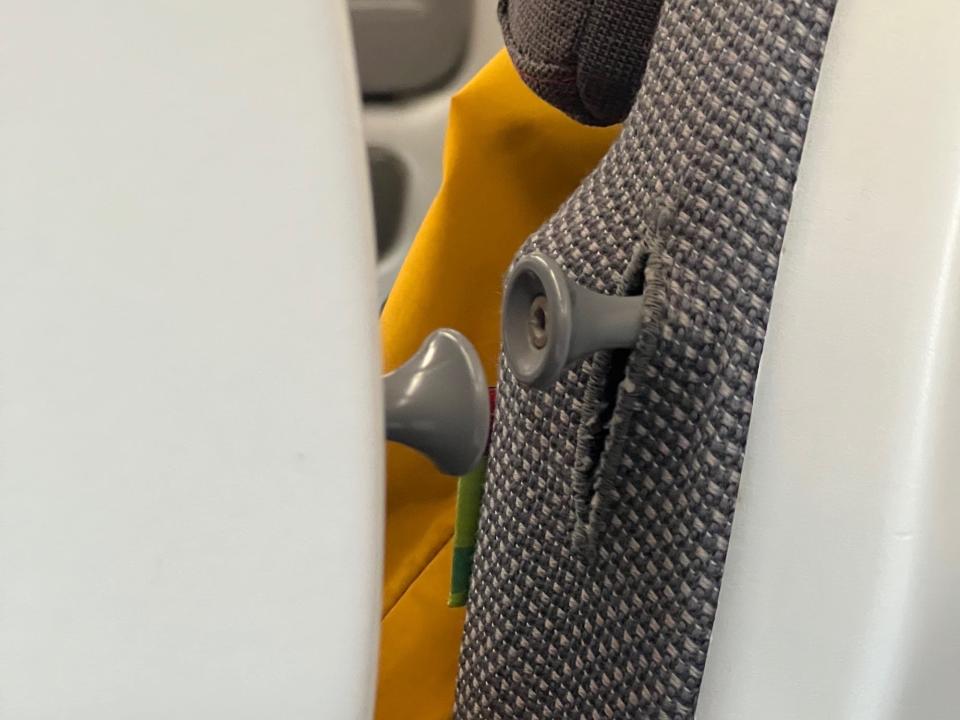 The coat hooks poking out from between the seats.