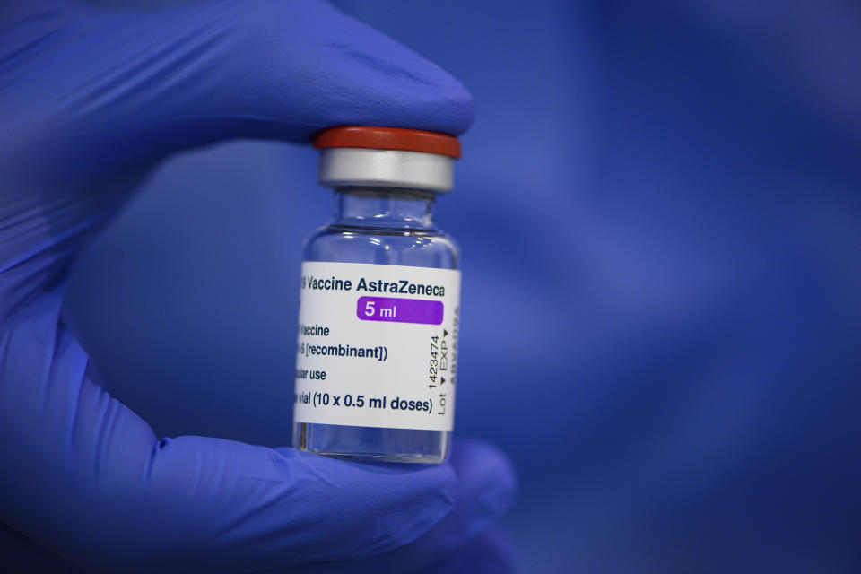 FILE - In this March 20, 2021 file photo an employee at the vaccination centre at Messe Dresden holds a vial of Astrazeneca's active ingredient against Corona in his hand in Dresden, Germany. Countries in the European Union have ramped up the vaccination after sluggish start. The uptick comes as countries across Europe also grapple with a rise in infections that has pushed the EU’s overall number of confirmed cases close to 30 million.(Robert Michael/dpa via AP, file)