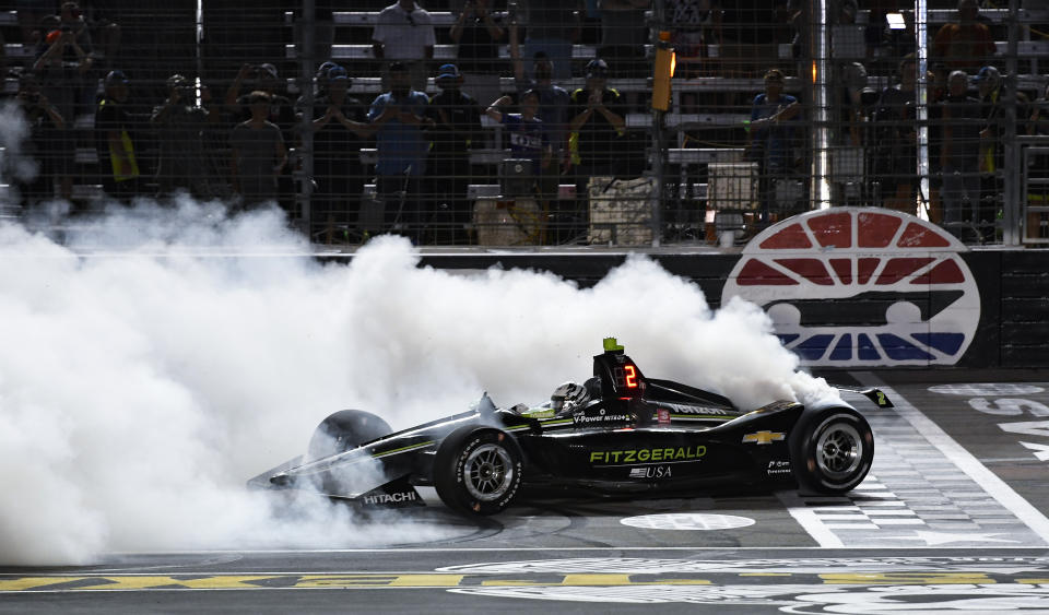 Josef Newgarden does a burnout after winning the IndyCar auto race at Texas Motor Speedway, Saturday, June 8, 2019, in Fort Worth, Texas. (AP Photo/Larry Papke)