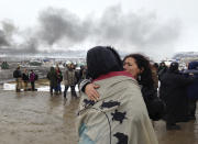 <p>A couple embraces as opponents of the Dakota Access pipeline leave their main protest camp Wednesday, Feb. 22, 2017, near Cannon Ball, N.D., as authorities were preparing to shut down the camp in advance of spring flooding season. The Army Corps of Engineers ordered the camp closed at 2 p.m. Wednesday. (Photo: James MacPherson/AP) </p>
