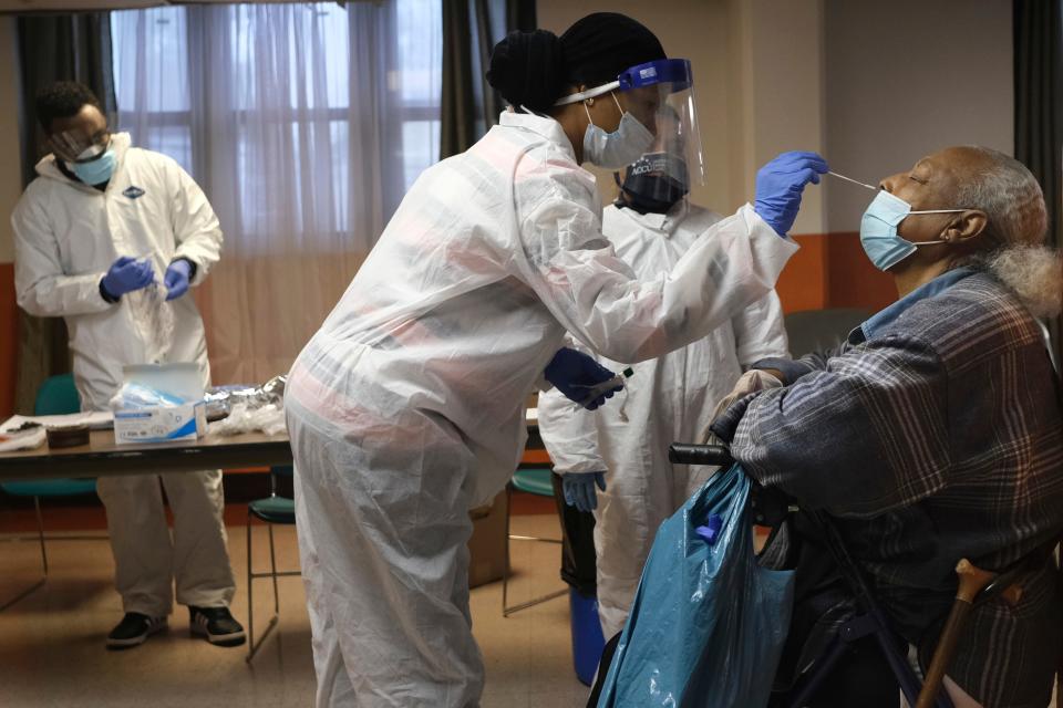 Mary Mack, right, a resident of senior housing, is tested for COVID-19 in Paterson, N.J., Friday, May 8, 2020. New York City is offering to test all nursing home residents and staffers for the coronavirus.