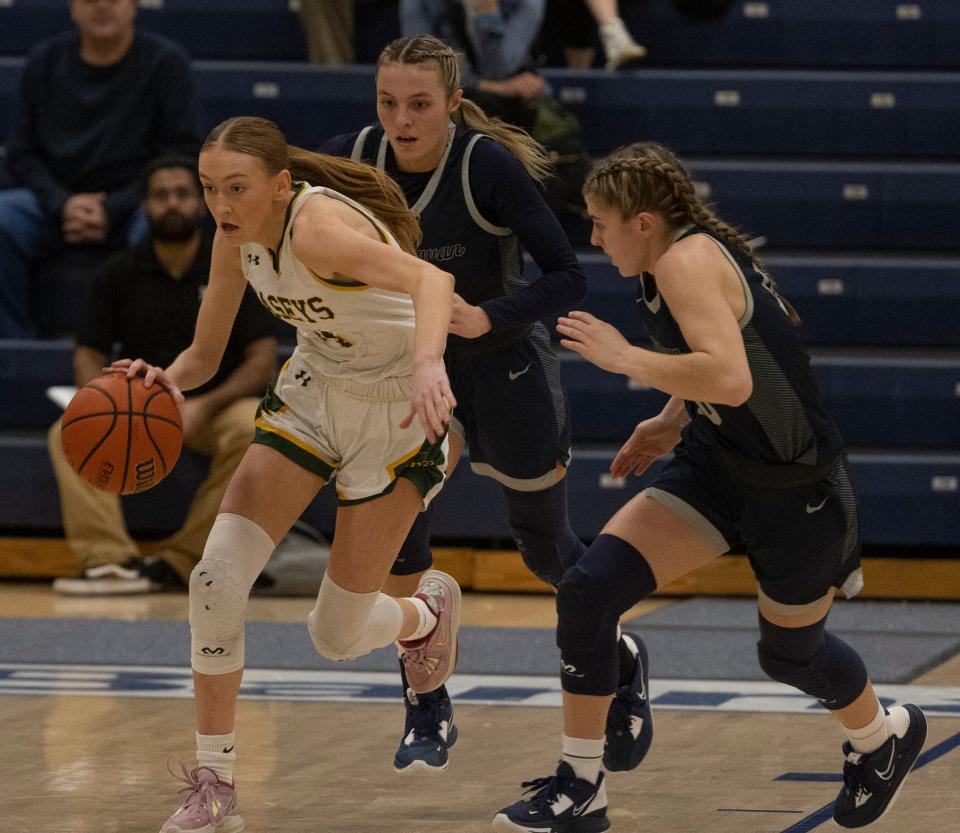 RBC Molly Kelly drives down the court with Manasquan McKenna Karlson and Olivia Shaughnessy on her back. Red Bank Catholic Girls Basketball vs Manasquan in Shore Conference Semifinal game in Toms River NJ on February 15, 2023. 