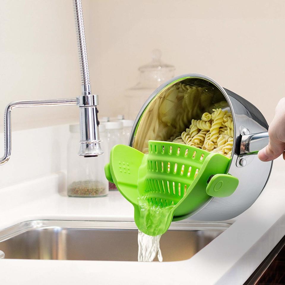 Model using the colander to strain noodles