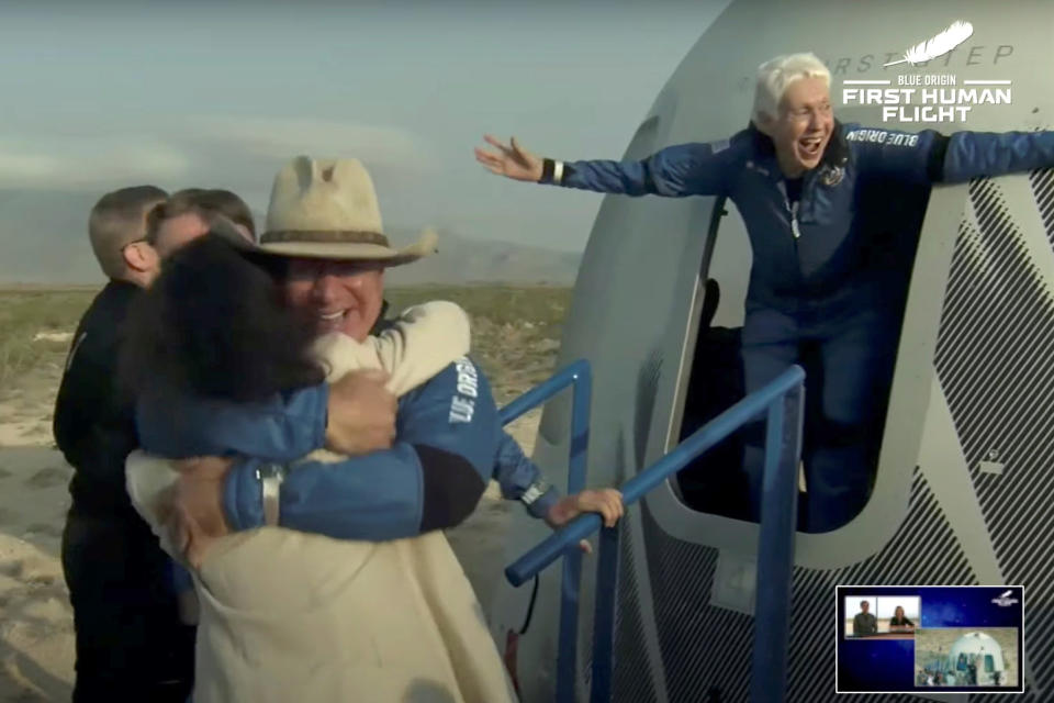 Image: Billionaire businessman Jeff Bezos and pioneering female aviator Wally Funk emerge from their capsule (Blue Origin / Reuters)