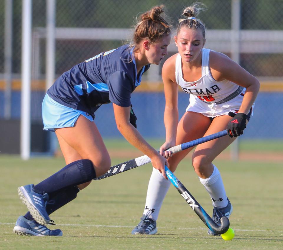 Cape Henlopen's Louise Rishko (left) tries to move the ball upfield as Delmar's Baylie Phillips moves in during the second half of the Wildcats' 2-1 win at Delmar High School, Thursday, Oct. 6, 2022.