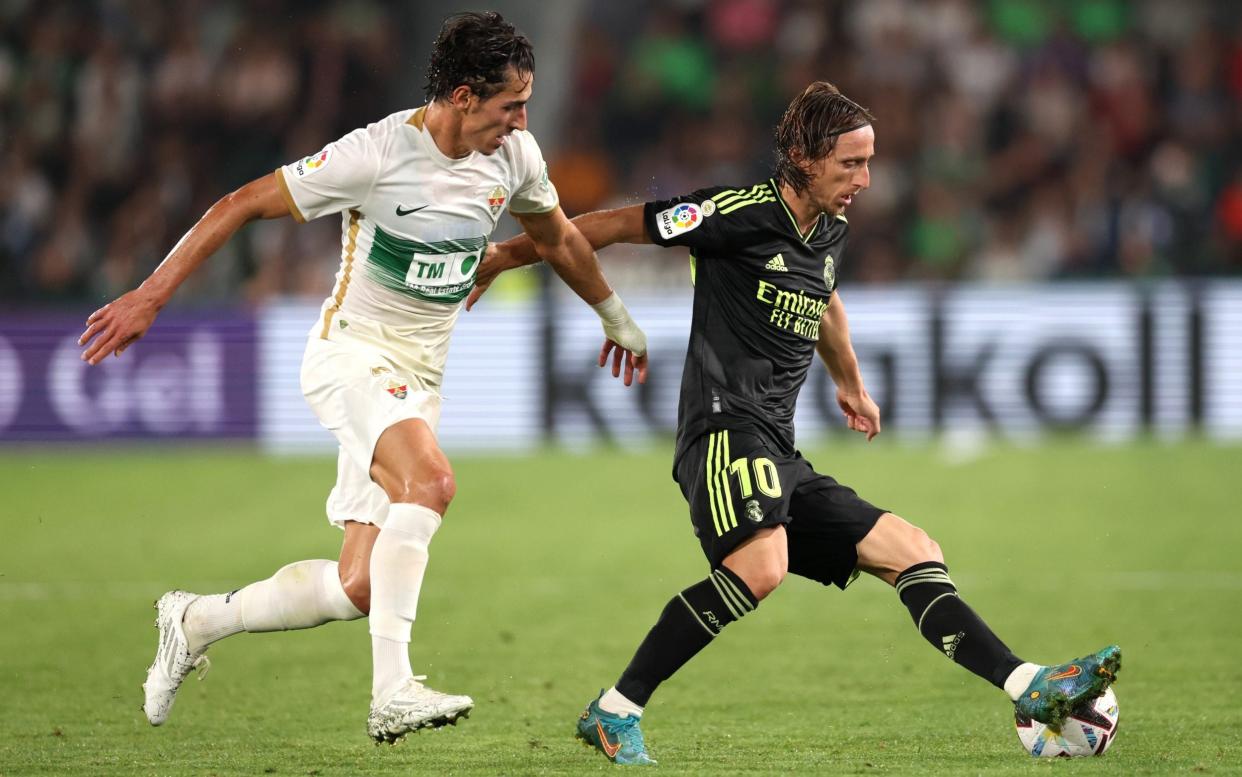Luka Modric of Real Madrid is challenged by Pere Milla of Elche during the LaLiga Santander match between Elche CF and Real Madrid CF - Clive Brunskill/Getty Images