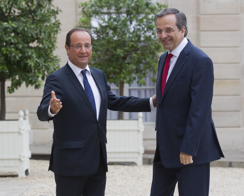 France’s President Francois Hollande, left, welcomes Greece's Prime Minister Antonis Samaras at the Elysee Palace, Paris, Saturday, Aug. 25, 2012. (AP Photo/Michel Euler)