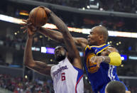 Los Angeles Clippers center DeAndre Jordan, left, puts up a shot as Golden State Warriors forward Marreese Speights defends during the first half in Game 1 of an opening-round NBA basketball playoff series, Saturday, April 19, 2014, in Los Angeles. (AP Photo/Mark J. Terrill)