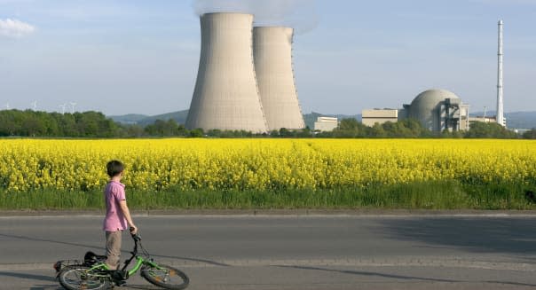 Young Boy with Bicycle Looking at Nuclear Power Station