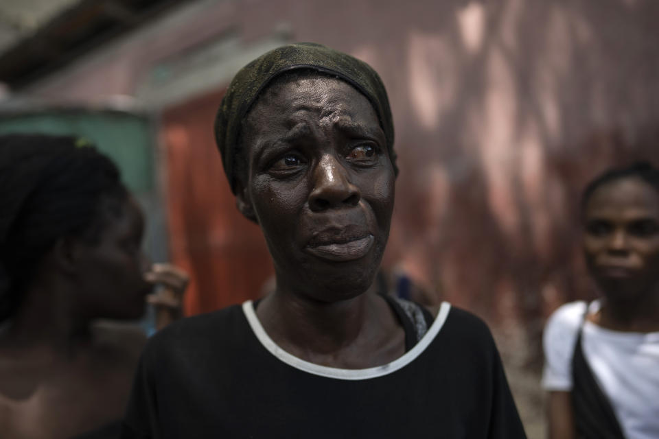 Dieu Frisdeline, who has sought refuge in Jean-Kere Almicar's front yard, cries as she tells how she was raped by gang members, in Port-au-Prince, Haiti, Sunday, June 4, 2023. Nearly 200 people who once lived in the Cite Soleil slum near Almicar’s house are now camped out in his front yard and nearby areas. They are among the nearly 165,000 Haitians who have fled their homes amid a surge in gang violence. (AP Photo/Ariana Cubillos)