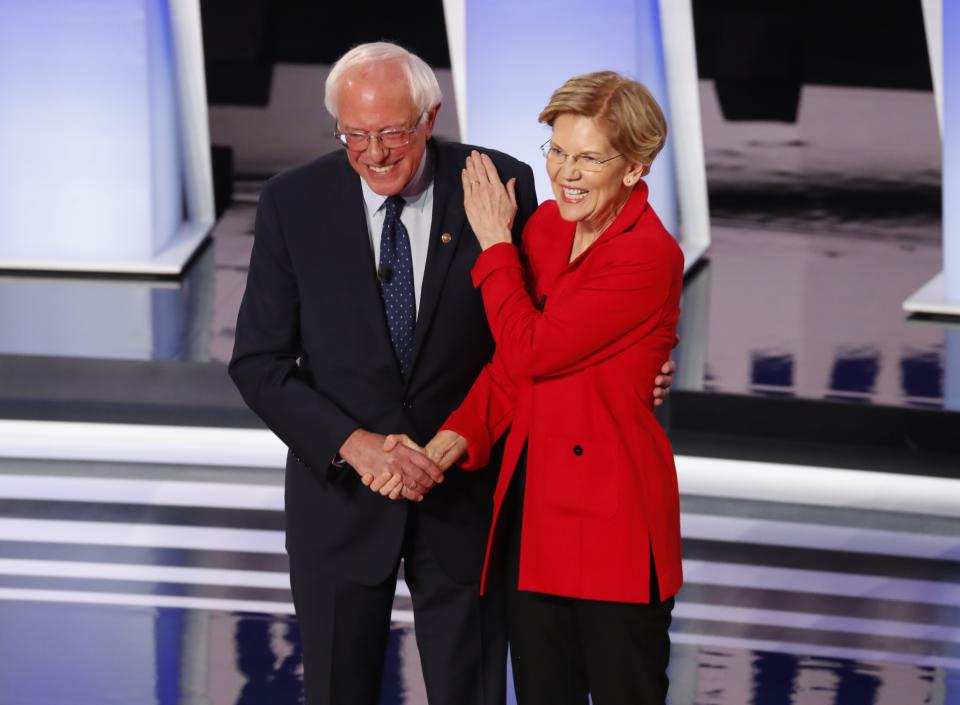 Sen. Bernie Sanders, I-Vt., and Sen. Elizabeth Warren, D-Mass., greet each other before the first of two Democratic presidential primary debates hosted by CNN Tuesday, July 30, 2019, in the Fox Theatre in Detroit. (AP Photo/Paul Sancya)