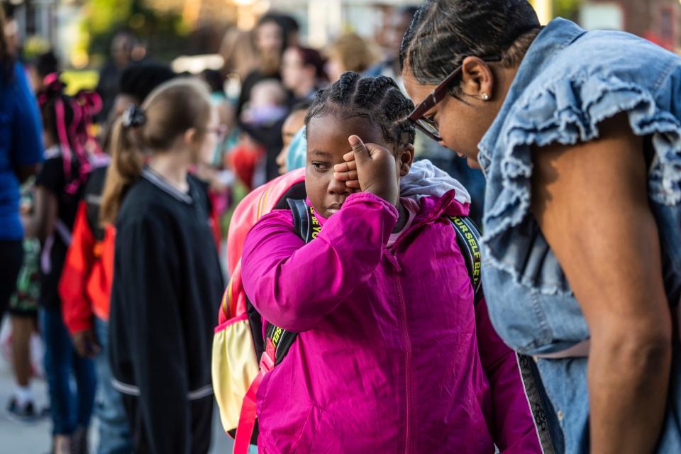 Pleasantview Elementary School third grader Brooklyn Anderson wipes tears away while talking with her mother, Sheree Anderson, as she waits outside of her school with other students before the start of the first day of school at Pleasantview Elementary School in Eastpointe on Monday, Aug. 28, 2023.