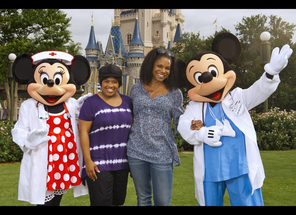 'Grey's Anatomy' star Chandra Wilson (L) and 'Private Practice' star Audra McDonald (R) pose with Nurse Minnie Mouse and Dr. Mickey Mouse June 28, 2011 at the Magic Kingdom park in Lake Buena Vista, Florida.     (Photo by Matt Stroshane/Disney Parks via Getty Images)