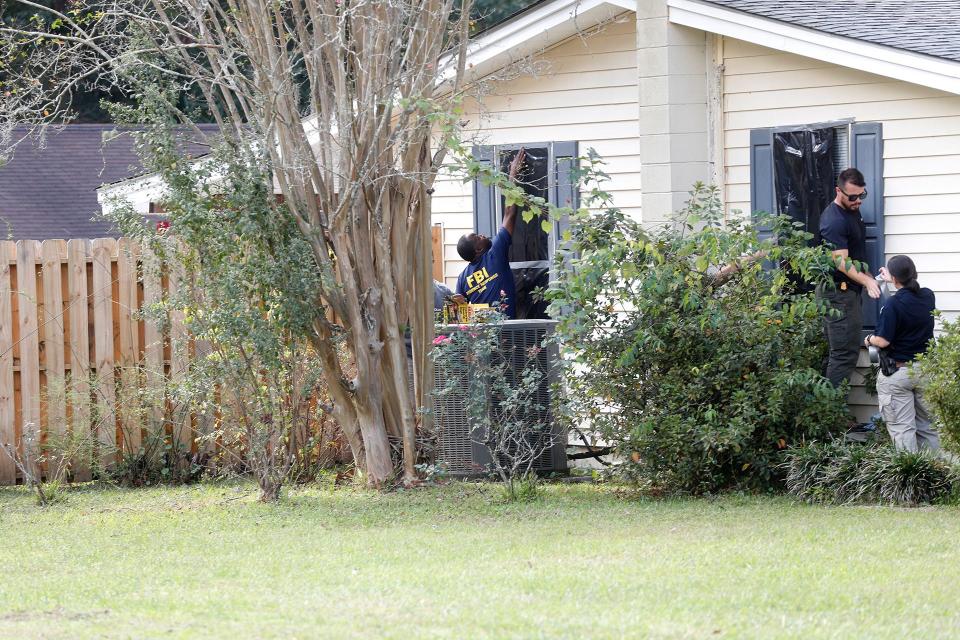 Agents from the Federal Bureau of Investigation tape dark plastic over windows at the residence where Quinton Simon was last seen on Wednesday October 5, 2022.