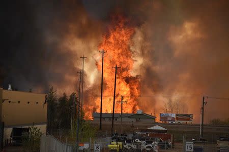 Flames rise in Industrial area south Fort McMurray, Alberta Canada May 3, 2016. Courtesy CBC News/Handout via REUTERS