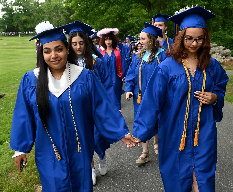 Keefe Regional Technical School class president Alexis Pena, left, and Kati Santiago hold hands as they enter their graduation ceremony at the Warren Conference Center and Inn in Ashland, June 2, 2022.