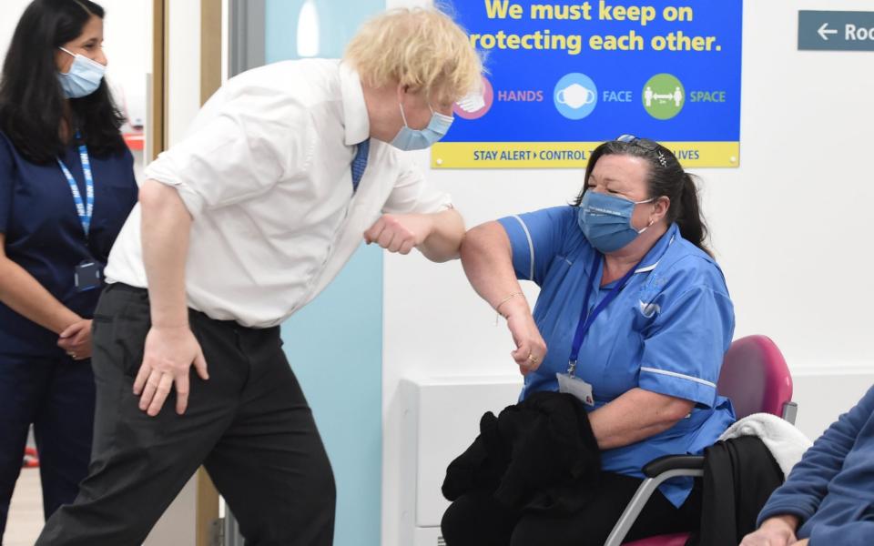 Boris Johnson meets nurse Michelle Bradford during a visit to a coronavirus vaccination centre at the Health and Well-being Centre in Orpington - PA