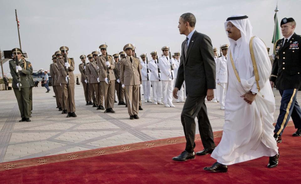 President Barack Obama walks past an honor guard during the arrival ceremony at King Khalid International airport in Riyadh, Saudi Arabia, Friday, March 28, 2014. President Barack Obama is in Saudi Arabia to reassure the key Gulf ally that his commitment to the Arab world isn't wavering. (AP Photo/Pablo Martinez Monsivais)