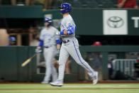 Kansas City Royals' Whit Merrifield rounds the bases after hitting a solo home run in the third inning of a baseball game against the Texas Rangers, Wednesday, May 11, 2022, in Arlington, Texas. (AP Photo/Tony Gutierrez)