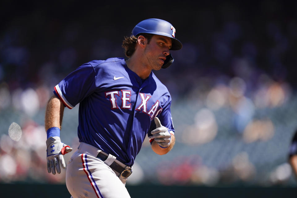 Texas Rangers designated hitter DJ Peters runs the bases after hitting a home run during the third inning of a baseball game against the Los Angeles Angels Sunday, Sept. 5, 2021, in Anaheim, Calif. Adolis Garcia and Nathaniel Lowe also scored. (AP Photo/Ashley Landis)