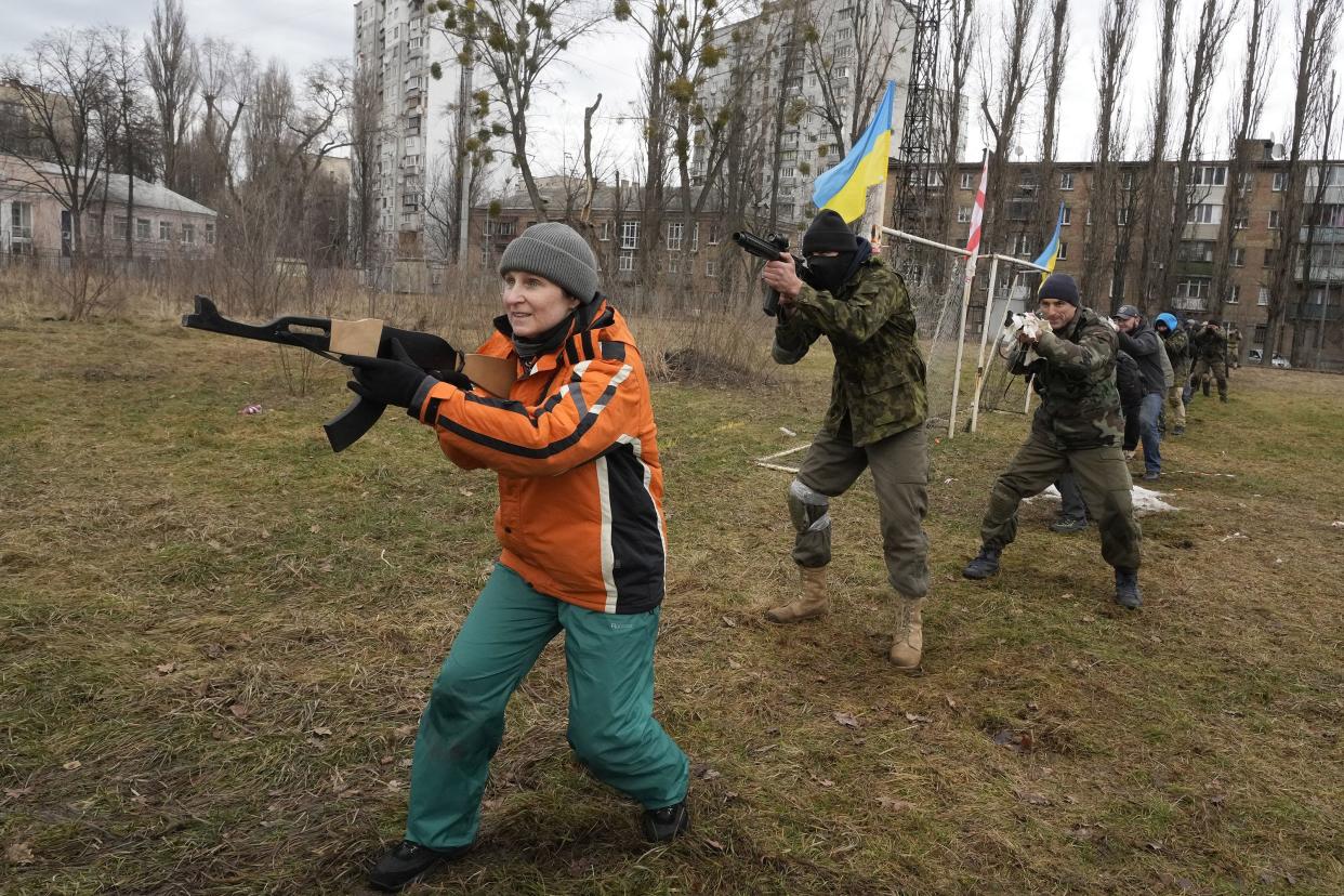 Civilians train with members of the Georgian Legion, a paramilitary unit formed mainly by ethnic Georgian volunteers to fight against Russian forces in Ukraine in 2014, in Kyiv, Ukraine, Saturday, Feb. 19, 2022. Separatist leaders in eastern Ukraine have ordered a full military mobilization amid growing fears in the West that Russia is planning to invade the neighboring country. The announcement on Saturday came amid a spike in violence along the line of contact between Ukrainian forces and the pro-Russia rebels in recent days.