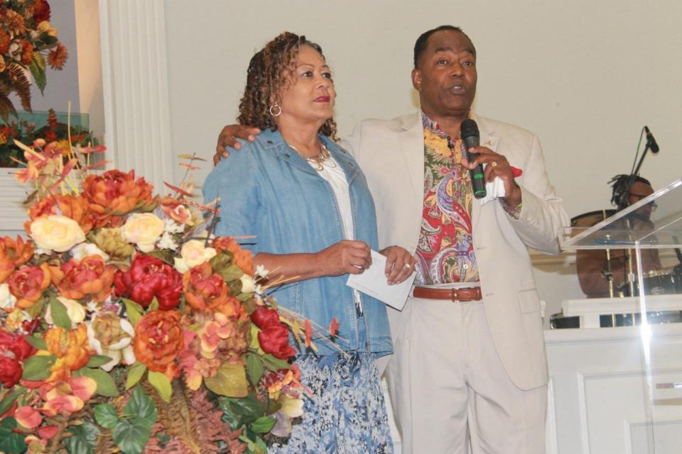 Senior pastors and co-founders of PASSAGE Family Church, Lady Michele Dix and her husband Pastor George B. Dix, stand before parishioners during the church's annual Family and Friends Day service on Sunday.