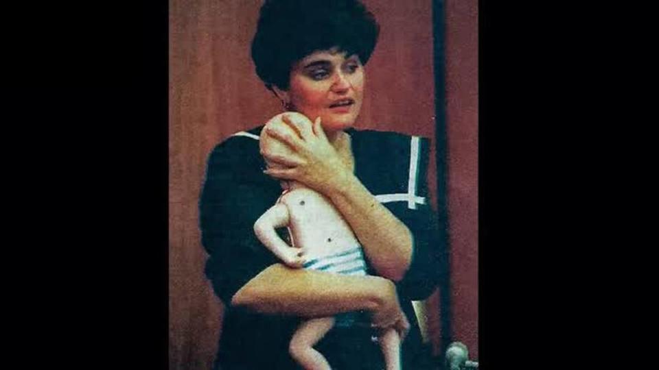 Brenda Gail Cutro holds a doll in court at the request of prosecutors.