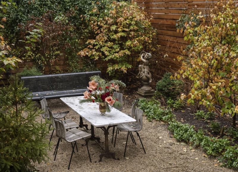 The outdoor sitting areas atop a gravel and plant cover outdoor space.