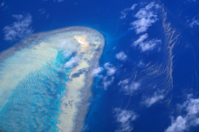 FILE PHOTO: Coral surrounds a small island on the Great Barrier Reef, located off the coast of Queensland, near the town of Rockhampton