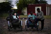 Tricycle drivers attend an outdoor movie screening held by a NGO in Phnom Penh