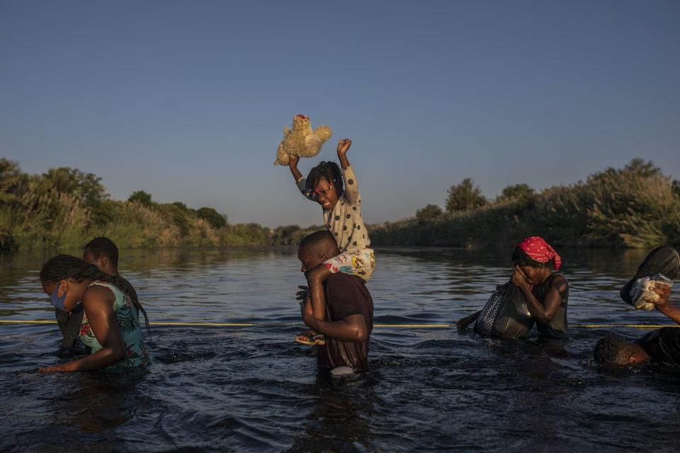 Migrants wade across the Rio Grande from Texas to Mexico to avoid deportation. <a href="https://newsroom.ap.org/detail/ExodustoAmerica-AsylumBan/389eb605e83b414fb1a7ba7d554742b2/photo?Query=US%20deporting%20asylum&mediaType=photo&sortBy=arrivaldatetime:desc&dateRange=Anytime&totalCount=244&currentItemNo=2" rel="nofollow noopener" target="_blank" data-ylk="slk:AP Photo/Felix Marquez;elm:context_link;itc:0;sec:content-canvas" class="link ">AP Photo/Felix Marquez</a>