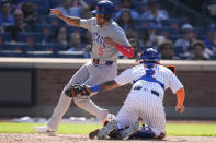 New York Mets catcher Omar Narváez, right, tags out Chicago Cubs' Christopher Morel as he tries to score during the 10th inning of a baseball game at Citi Field, Thursday, May 2, 2024, in New York. (AP Photo/Seth Wenig)