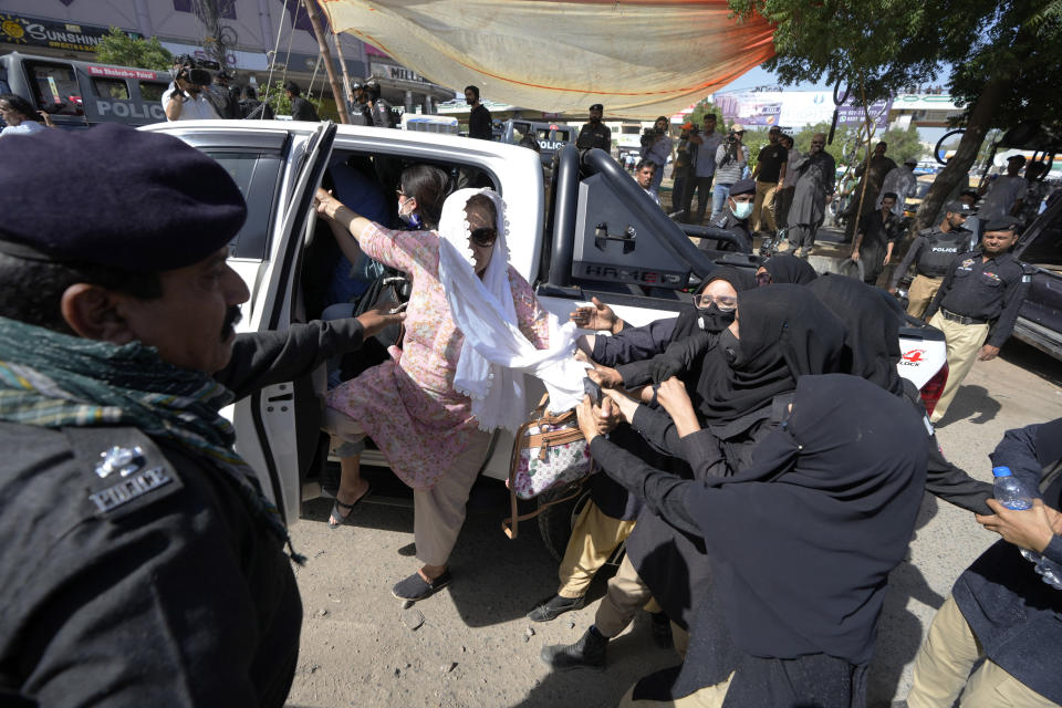 Police detain a supporter of Pakistan's former Prime Minister Imran Khan who along with others are protesting against the arrest of their leader, in Karachi, Pakistan, Wednesday, May 10, 2023. Khan can be held for eight days, a court ruled Wednesday, a day after the popular opposition leader was dragged from a courtroom and arrested on corruption charges, deepening the country's political turmoil. (AP Photo/Fareed Khan)