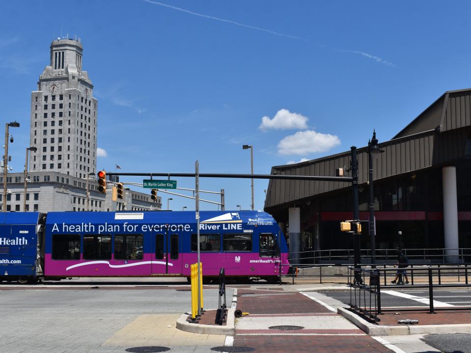 An NJ Transit River LINE light-rail train passes the Rand Transportation Center in downtown Camden.