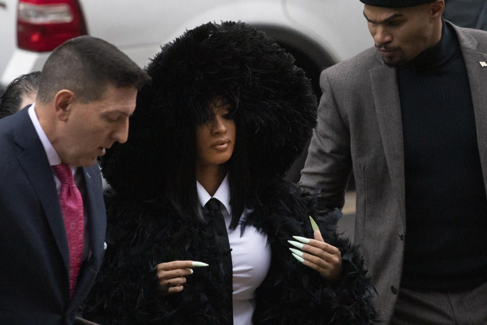 Rapper Cardi B arrives at Queens Criminal Court on charges stemming from an 2018 fight at a Queens strip club, Tuesday, Dec. 10, 2019 in New York. Prosecutors obtained a felony indictment in June. (AP Photo/Mark Lennihan)