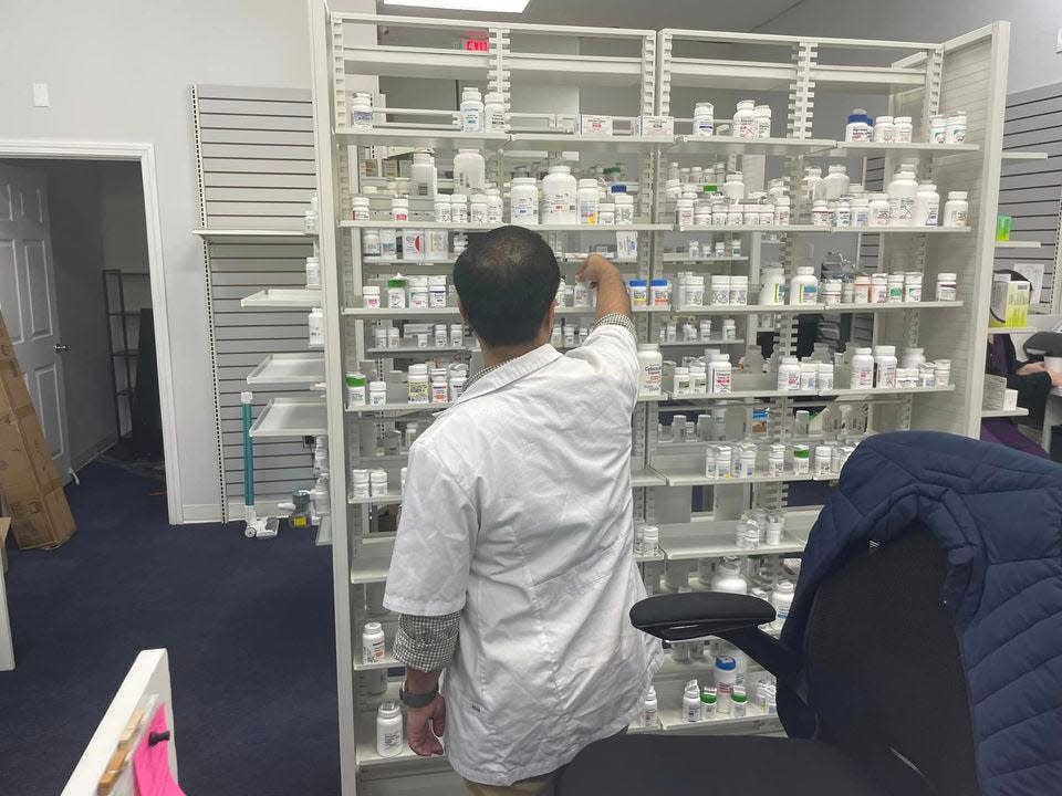 Norwich Pharmacy owner and pharmacist Zain Azam looking for a prescription. The pharmacy opened in April, and he said things are going well.