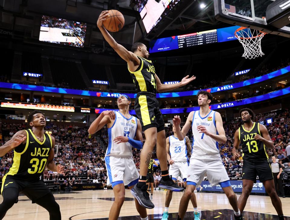 Utah Jazz’s Taevion Kinsey grabs a rebound over Oklahoma City Thunder’s Tre Mann and Chet Holmgren as they play in Summer League action at the Delta Center in Salt Lake City on Monday, July 3, 2023. Jazz lose 95-85. | Scott G Winterton, Deseret News