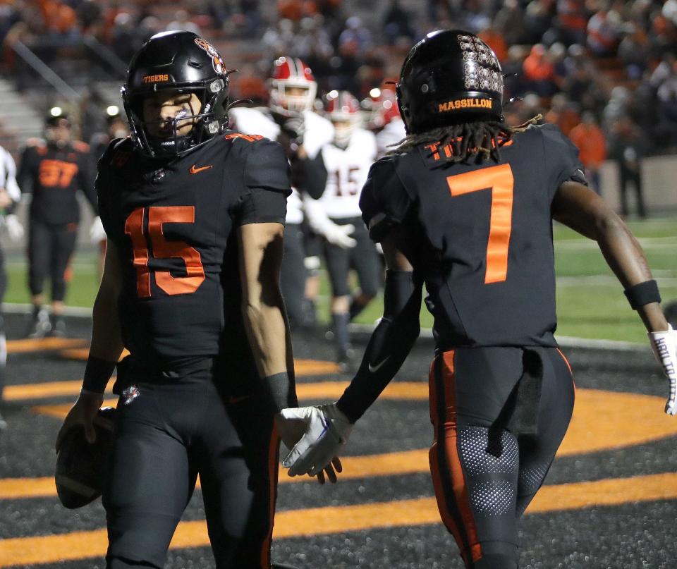 Massillon's Jacques Carter, right, and quarterback DaOne Owens (15) celebrate after an Owens' touchdown run during a playoff game against Westerville South, Friday, Nov. 3, 2023.