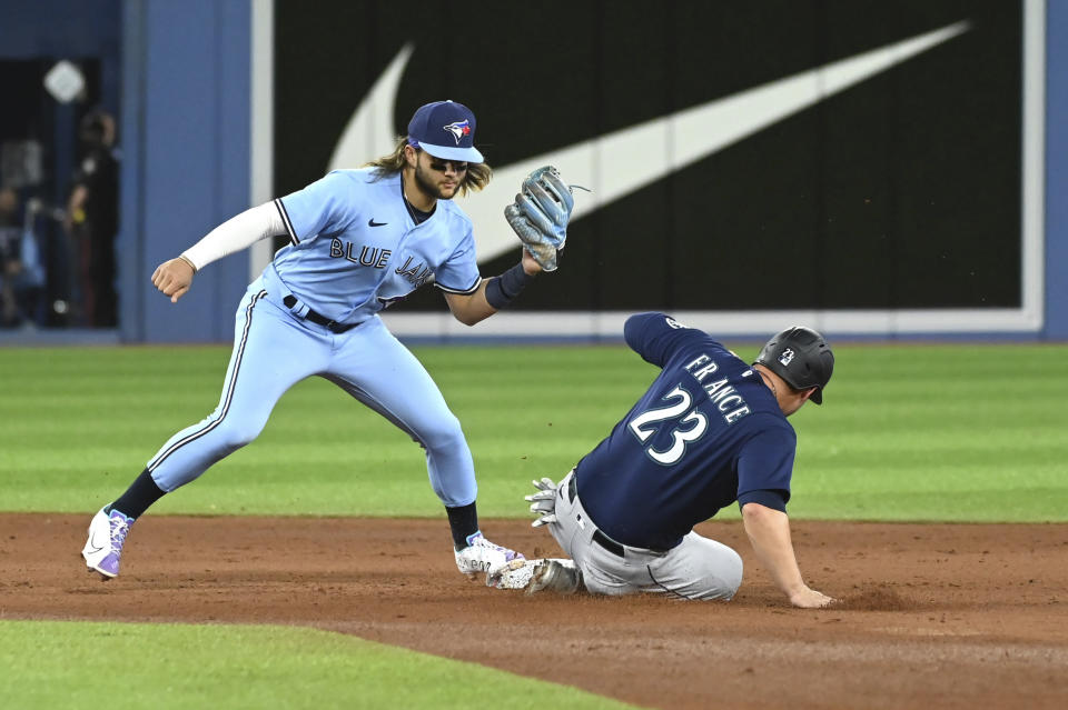 Toronto Blue Jays' Bo Bichette forces out Seattle Mariners' Ty France at second base during the fifth inning of a baseball game in Toronto on Wednesday, May 18, 2022. (Jon Blacker/The Canadian Press via AP)