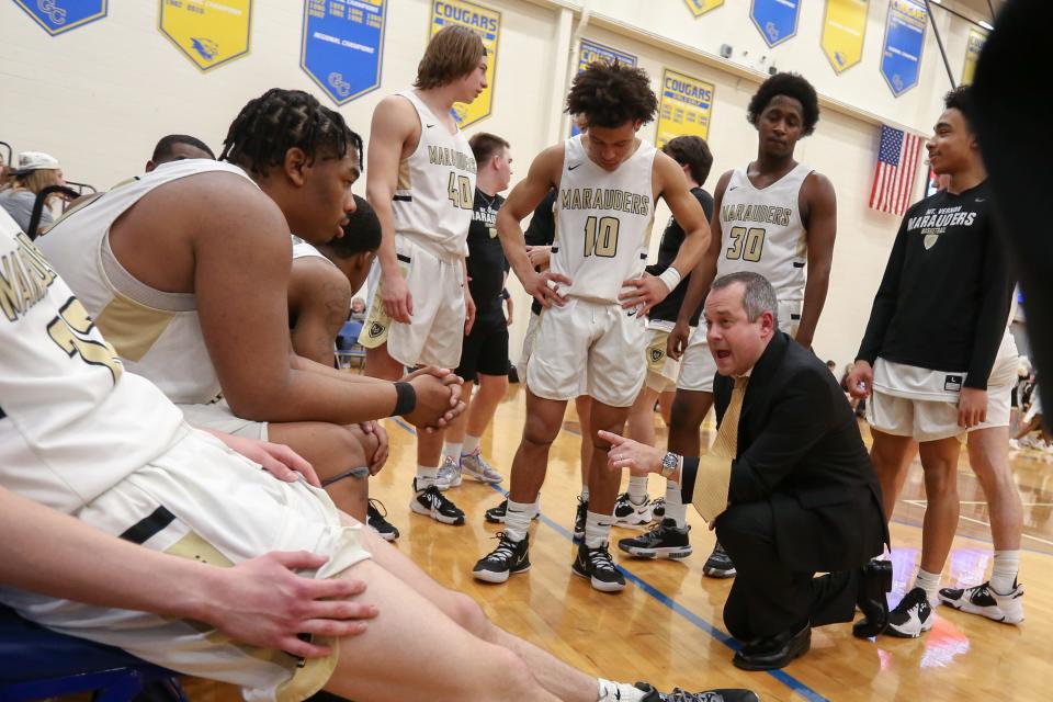 Mt. Vernon Coach Ben Rhoades talks to his players during a time out as New Palestine vs Mt. Vernon in the IHSAA 4A sectional championship,Mar 5, 2022; Greenfield, IN, at Greenfield-Central High School.